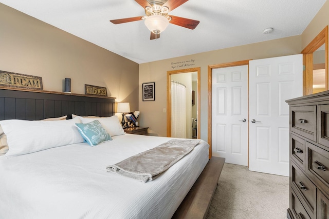 bedroom with ceiling fan and light carpet