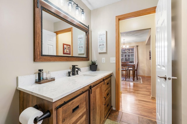 bathroom featuring an inviting chandelier and vanity