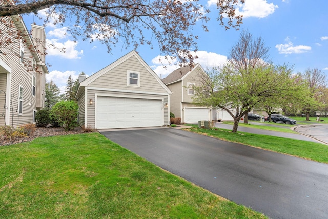 traditional-style home with a front lawn, driveway, and cooling unit