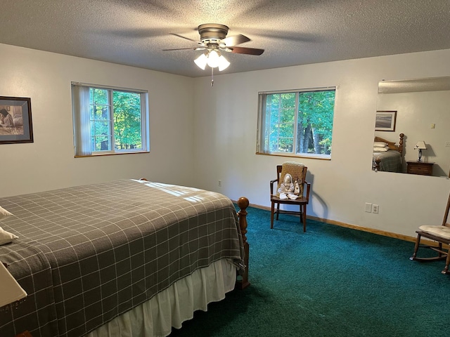 bedroom featuring ceiling fan, carpet floors, a textured ceiling, and baseboards