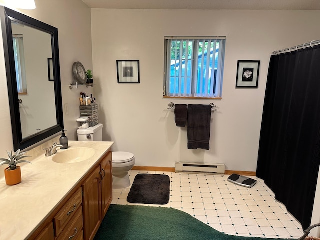 bathroom with a baseboard heating unit, vanity, toilet, and baseboards
