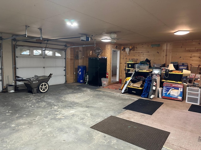 garage with freestanding refrigerator and a garage door opener