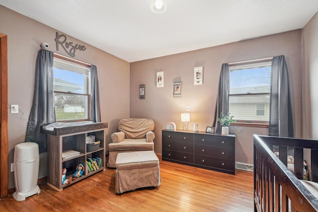 bedroom featuring visible vents and wood finished floors