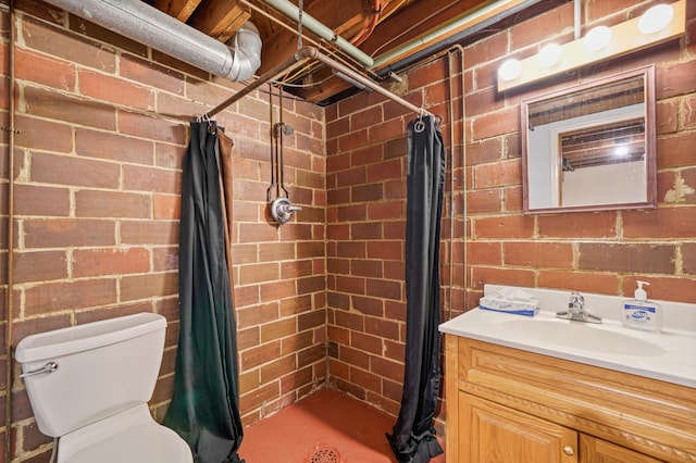 bathroom with toilet, vanity, and a stall shower