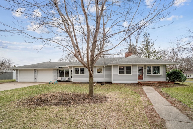 view of front facade with a garage, a chimney, a front lawn, and concrete driveway