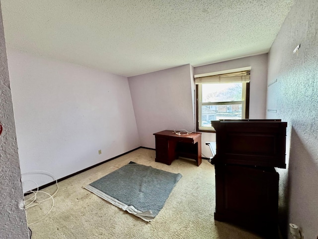 unfurnished bedroom with carpet flooring, a textured ceiling, and a textured wall