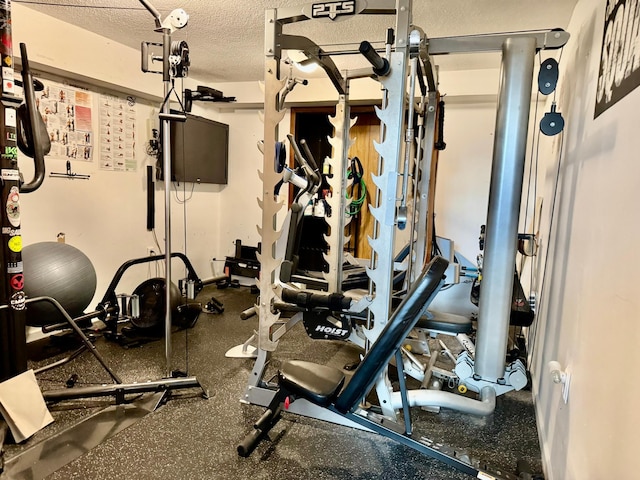 workout room with a textured ceiling
