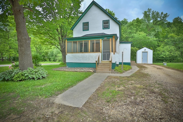 W340 State Road 29, Spring Valley, WI 54767 - view of front of home with a storage shed, a sunroom, stucco siding, entry steps, and a front yard