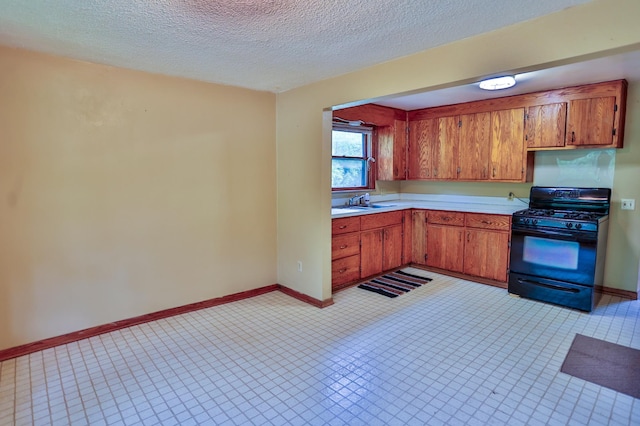 W340 State Road 29, Spring Valley, WI 54767 - kitchen featuring gas stove, light countertops, brown cabinetry, and a textured ceiling