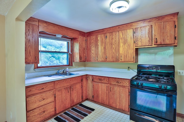 W340 State Road 29, Spring Valley, WI 54767 - kitchen featuring black gas stove, light countertops, and brown cabinetry