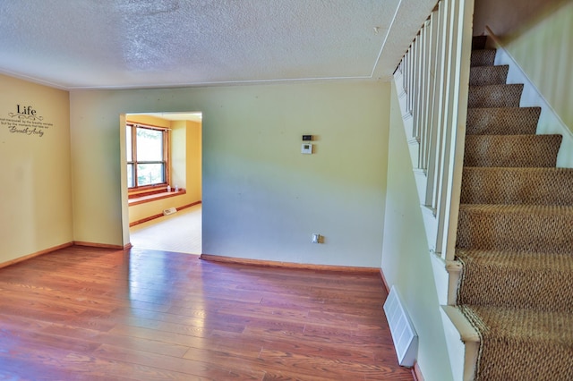 W340 State Road 29, Spring Valley, WI 54767 - stairs featuring a textured ceiling and wood finished floors