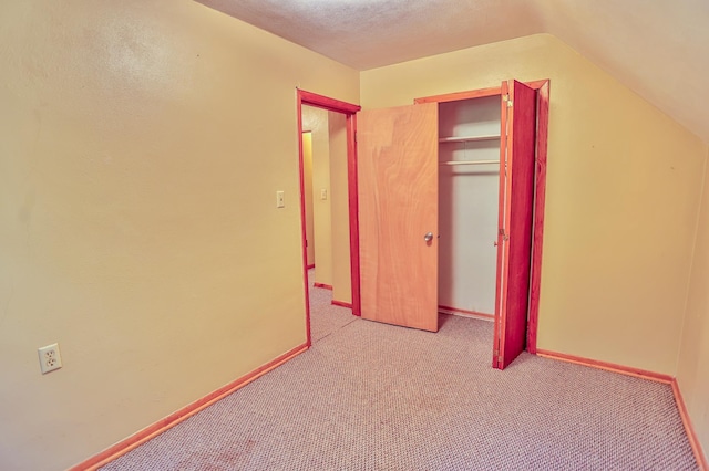 W340 State Road 29, Spring Valley, WI 54767 - unfurnished bedroom with light carpet, a closet, and lofted ceiling