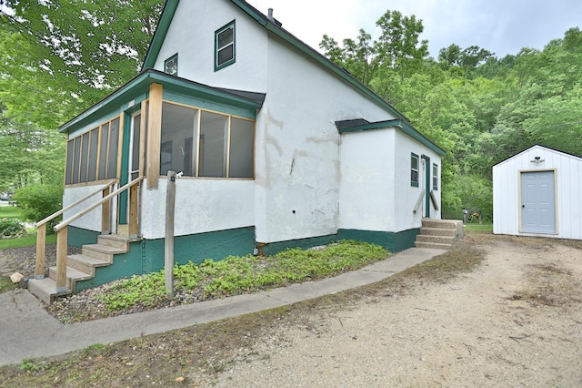 W340 State Road 29, Spring Valley, WI 54767 - view of front of house with entry steps, stucco siding, and a sunroom