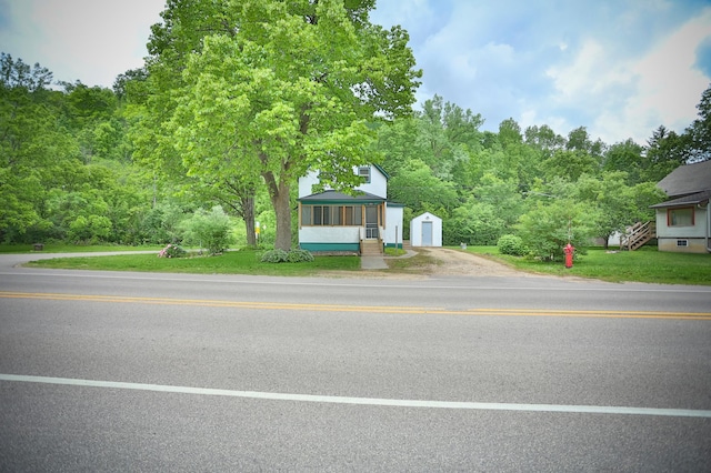 W340 State Road 29, Spring Valley, WI 54767 - view of front of property featuring a storage unit, dirt driveway, and a sunroom