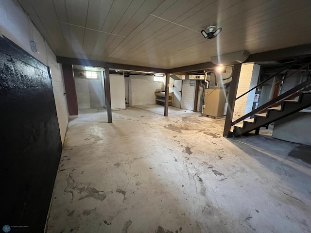 below grade area featuring heating unit and stairs