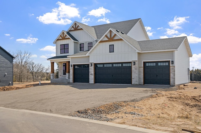 modern farmhouse with board and batten siding, driveway, a garage, and roof with shingles
