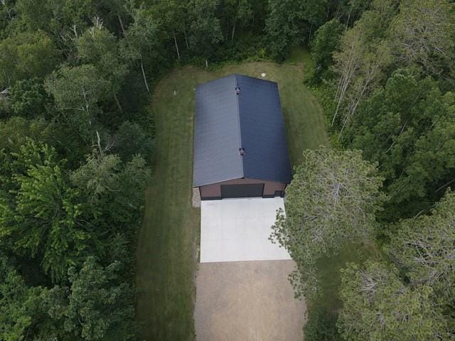 birds eye view of property featuring a view of trees