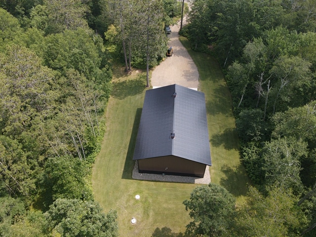 birds eye view of property with a forest view