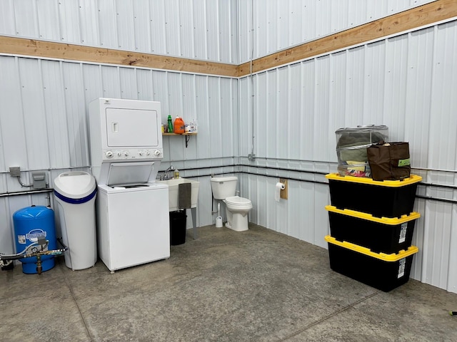 washroom with stacked washer / dryer and laundry area