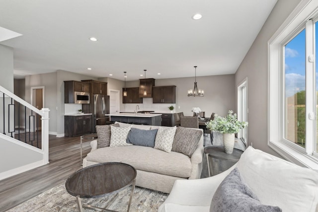 5323 177th St W, Lakeville, MN 55044 - living room featuring baseboards, a notable chandelier, recessed lighting, wood finished floors, and stairs