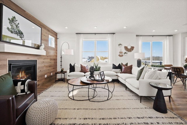 19321 Colonial Trl, Farmington, MN 55024 - living area with wood finished floors, a glass covered fireplace, recessed lighting, and wood walls
