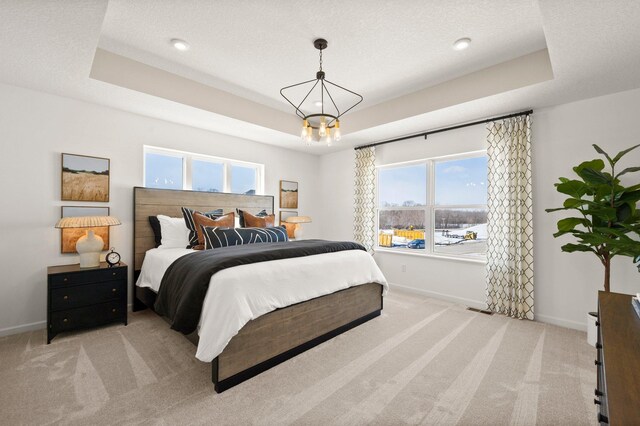 19321 Colonial Trl, Farmington, MN 55024 - bedroom featuring a tray ceiling, baseboards, and light carpet