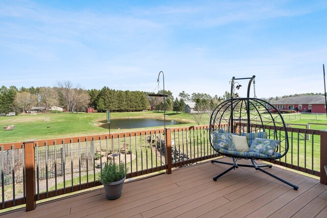 wooden terrace featuring a yard and a water view