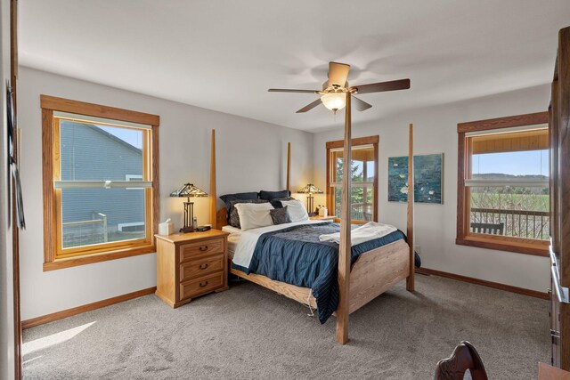 bedroom featuring baseboards, ceiling fan, and light carpet