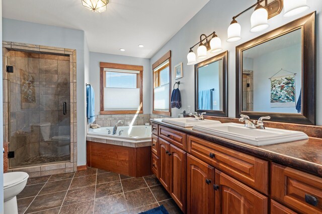 full bath featuring double vanity, a sink, a bath, and a stall shower