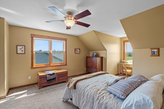 carpeted bedroom featuring baseboards, a ceiling fan, lofted ceiling, and multiple windows