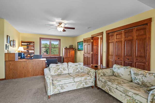 living room featuring ceiling fan and carpet