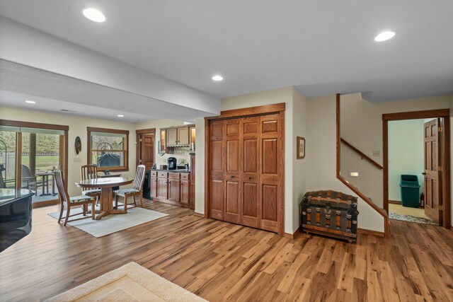 living room featuring stairway, recessed lighting, and light wood-type flooring