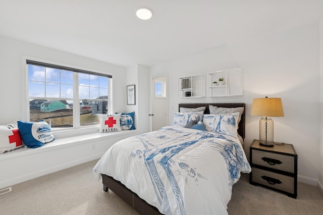 carpeted bedroom with visible vents and baseboards