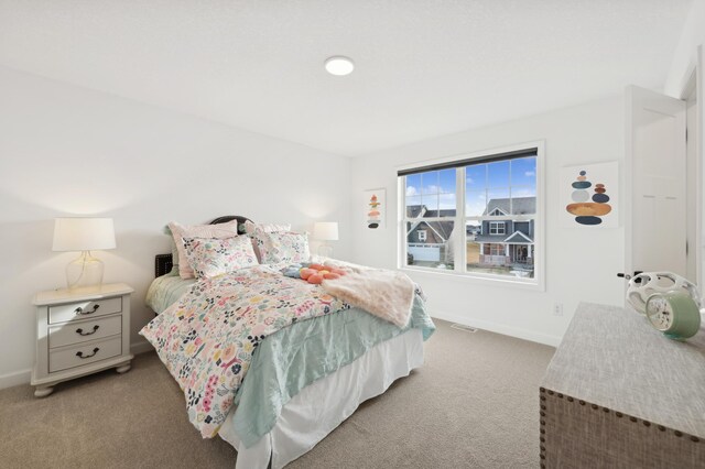carpeted bedroom with baseboards