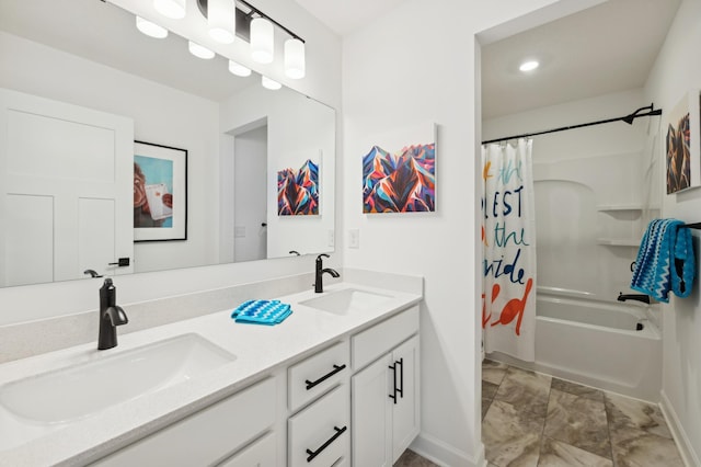 full bath featuring double vanity, shower / bath combo with shower curtain, baseboards, and a sink