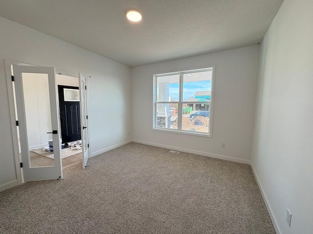 unfurnished bedroom with light carpet, visible vents, and baseboards