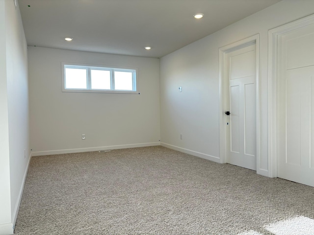 unfurnished room with baseboards, recessed lighting, and carpet
