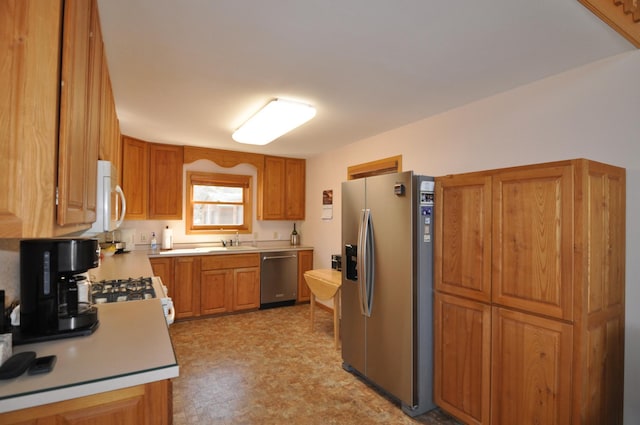 10179 Mounds Point Dr NW, Leech Lake Twp, MN 56633 - kitchen with stainless steel appliances, light countertops, brown cabinets, and light flooring