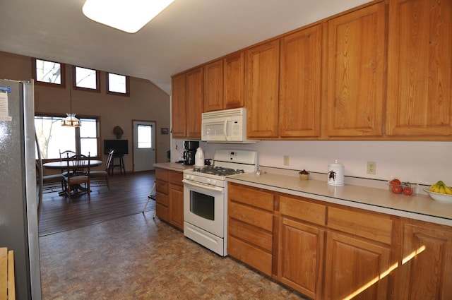 10179 Mounds Point Dr NW, Leech Lake Twp, MN 56633 - kitchen featuring white appliances, brown cabinets, light countertops, lofted ceiling, and decorative light fixtures