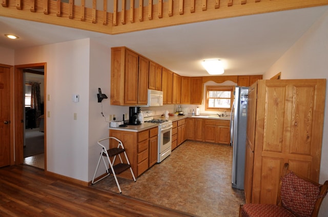 10179 Mounds Point Dr NW, Leech Lake Twp, MN 56633 - kitchen featuring white appliances, wood finished floors, light countertops, and brown cabinets