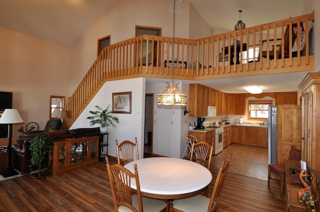 10179 Mounds Point Dr NW, Leech Lake Twp, MN 56633 - dining area with high vaulted ceiling, dark wood finished floors, and stairs
