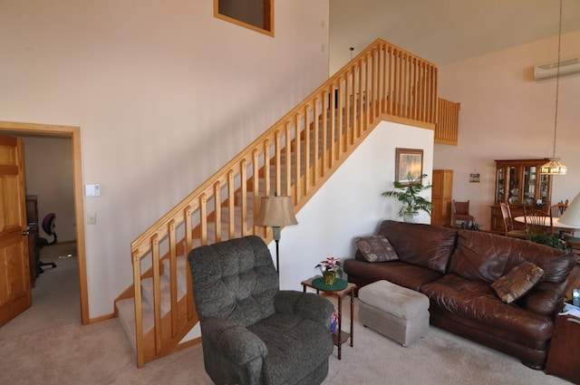 10179 Mounds Point Dr NW, Leech Lake Twp, MN 56633 - carpeted living area with a high ceiling, stairway, and a wall mounted AC