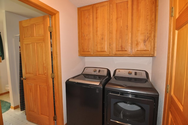 10179 Mounds Point Dr NW, Leech Lake Twp, MN 56633 - laundry area featuring washing machine and clothes dryer, cabinet space, and tile patterned floors