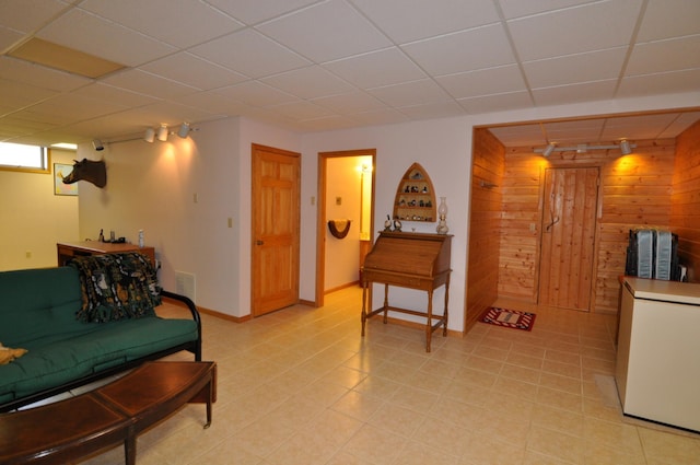 10179 Mounds Point Dr NW, Leech Lake Twp, MN 56633 - living room with wood walls and a drop ceiling
