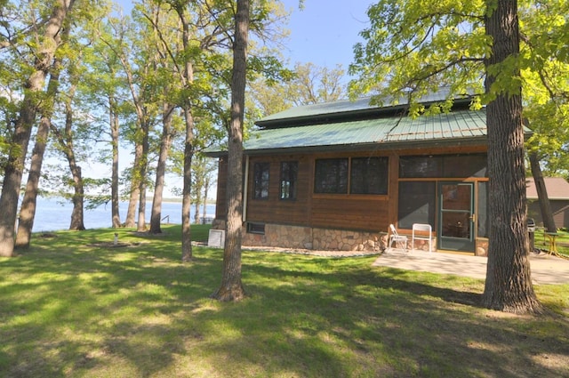 10179 Mounds Point Dr NW, Leech Lake Twp, MN 56633 - rear view of property featuring a water view, a yard, a patio, and a metal roof