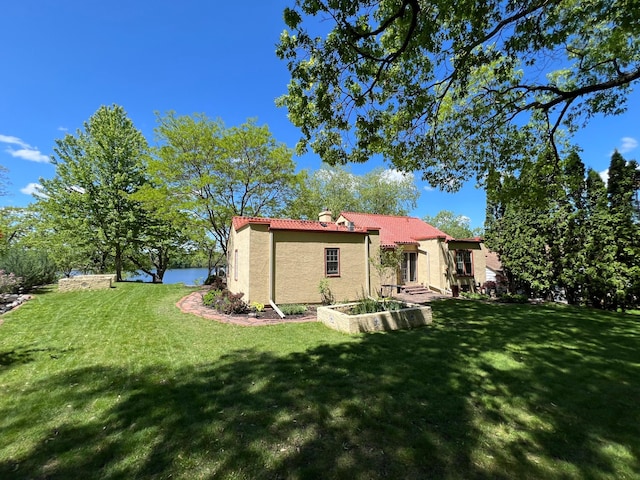 1260 Como Blvd E, Saint Paul, MN 55117 - back of house featuring a tiled roof, a yard, and stucco siding