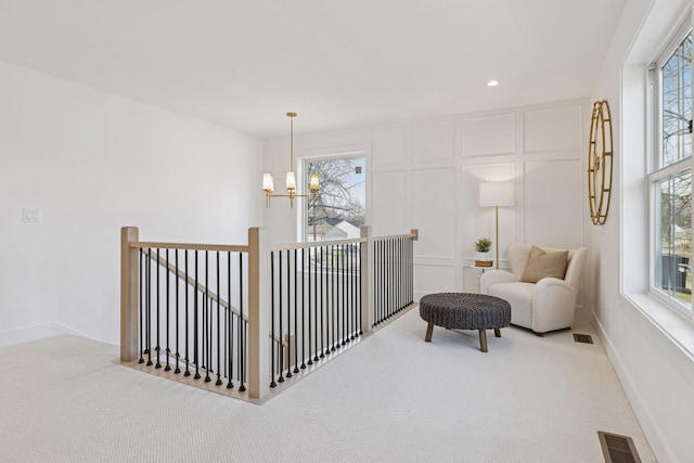 living area featuring an upstairs landing, carpet flooring, a chandelier, and recessed lighting
