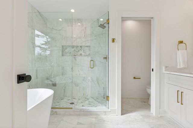 bathroom featuring marble look tiles, toilet, a marble finish shower, a freestanding bath, and vanity
