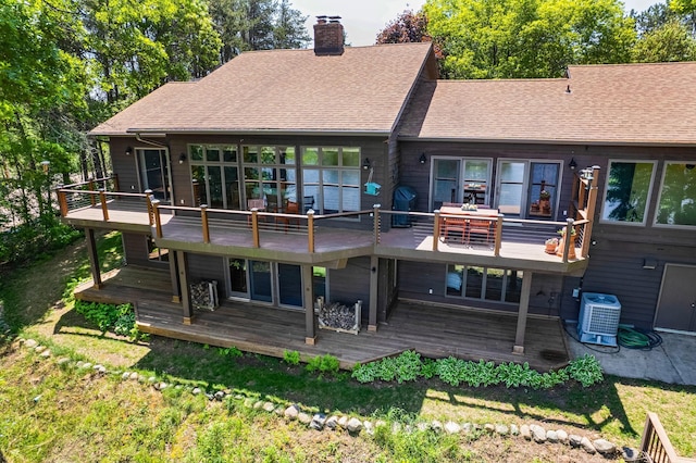 970 Brave Dr, Somerset, WI 54025 - back of property with a chimney, a yard, a wooden deck, and a shingled roof