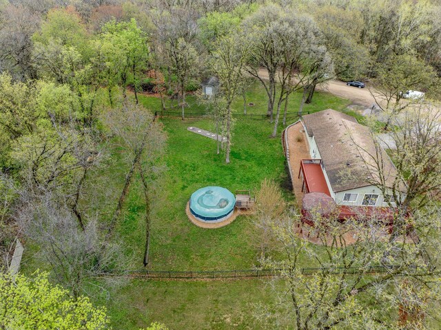 birds eye view of property featuring a view of trees
